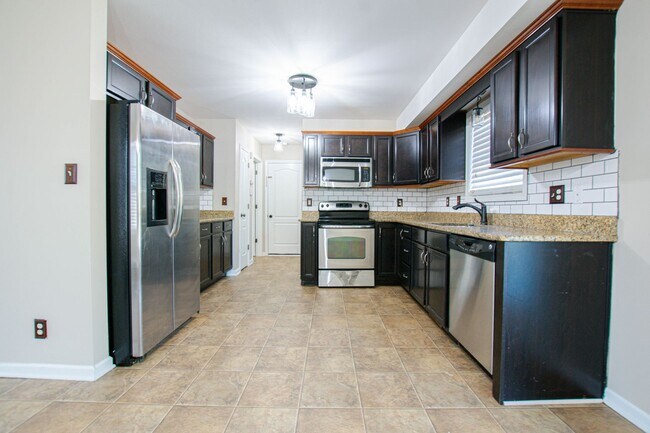 Building Photo - Pet Friendly Three Bedroom with Bonus!