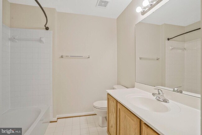 Building Photo - This beautifully maintained brick-front, three-level townhome is located in a highly sought-after...