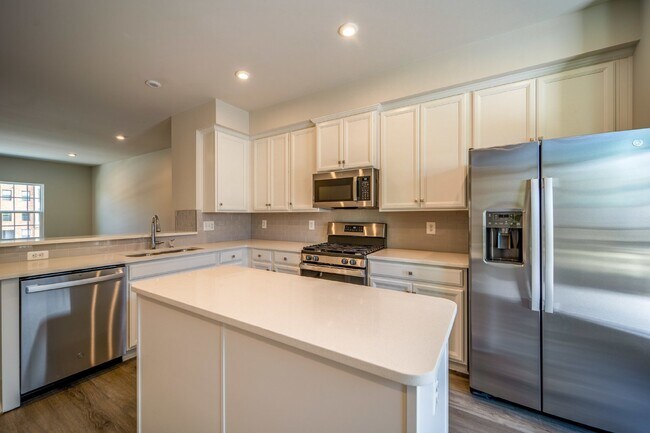 Building Photo - This 3-bedroom, 3-full bathroom townhouse offers a pristine and contemporary living experience.