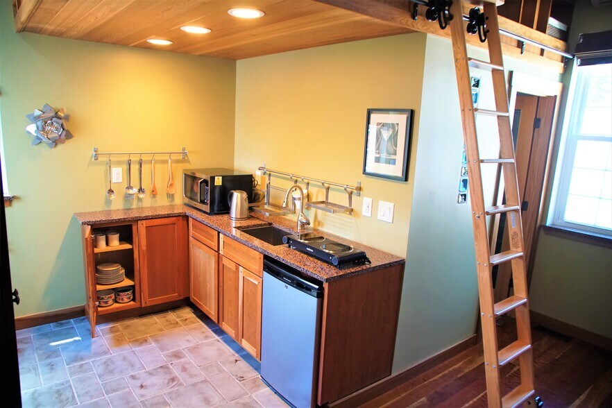 Kitchen before shelving was installed, convection microwave oven, full fridge by entrance door - 69 S Shannon Ave