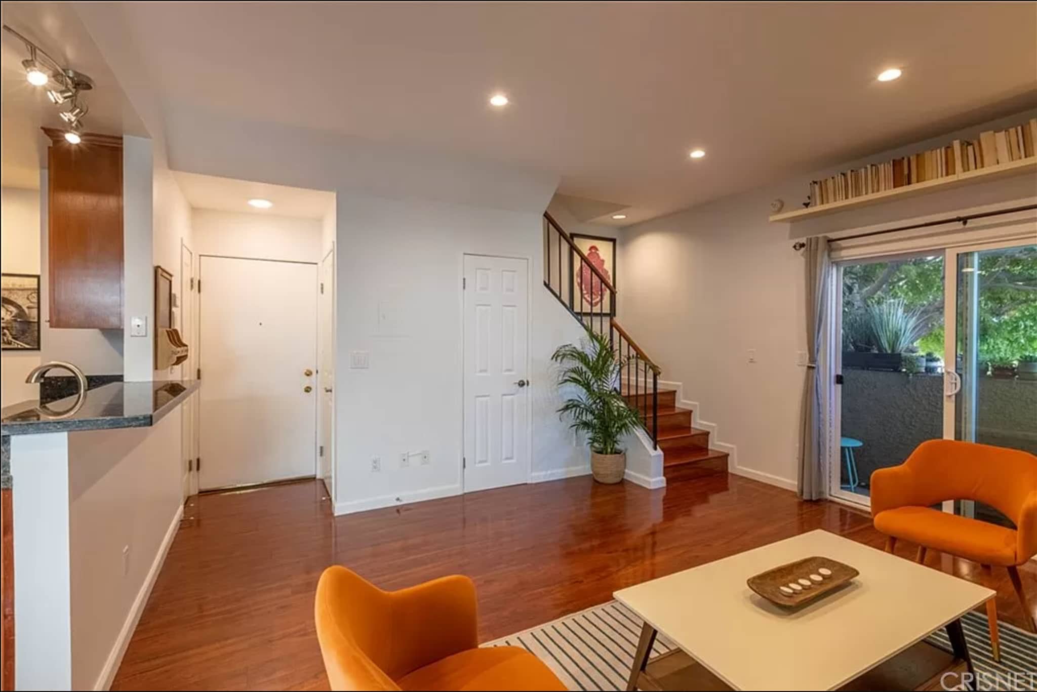 Entry way/living room. From left to right there is the kitchen, closet, front door, laundry, closet. - 1554 N Hobart Blvd