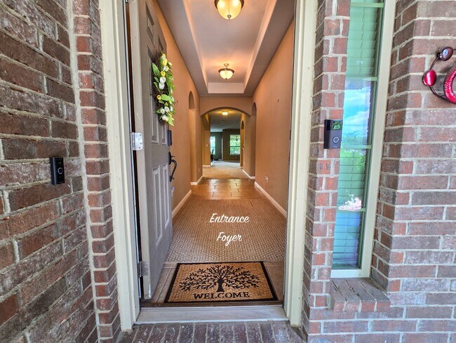 Step through the elegant front door into a spacious, light-filled foyer adorned with tile floors. - 301 Silver Trl