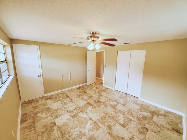 Building Photo - Three bedroom one and a half bathroom house with large yard space