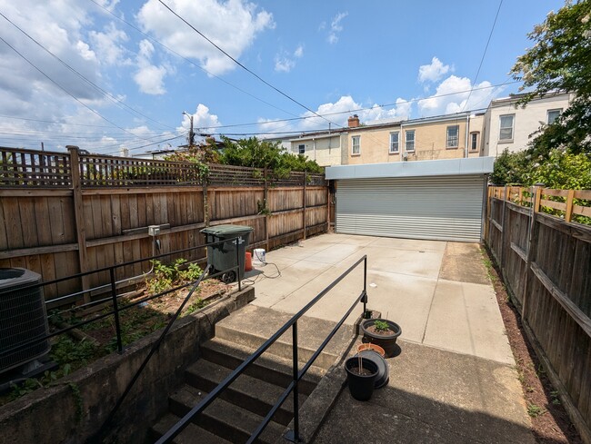 protected garage for two car parking with EV charging, newly installed garage door - 205 Bates St NW