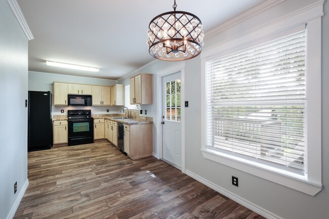Building Photo - ***APPLICATION CURRENTLY UNDER REVIEW***Modern Elegance: 3-Bedroom Townhome with Wood Flooring, S...