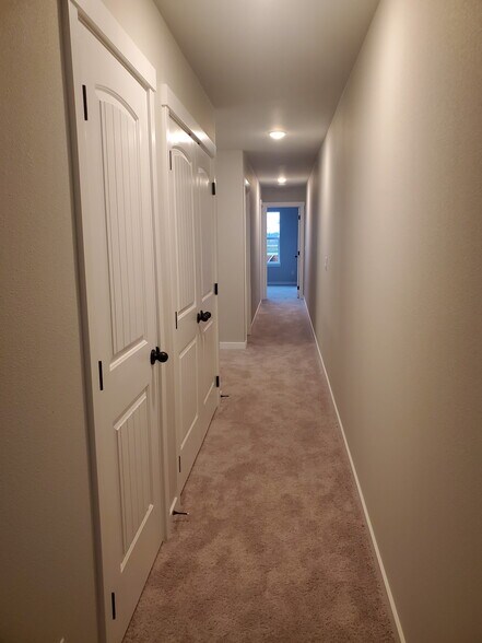 Upstairs hallway with the linen closet and washer/dryer behind the doors - 161 E Wayno Way