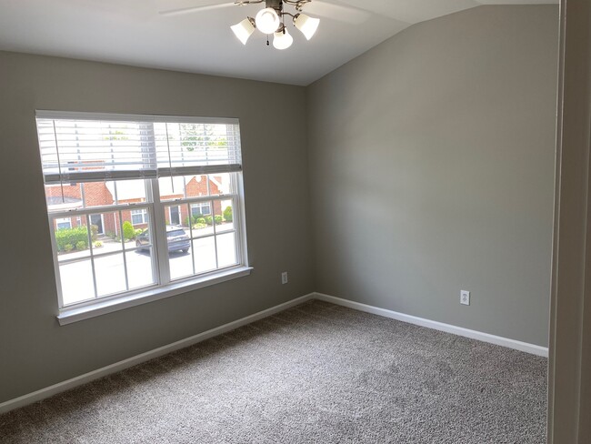 Sunny front-facing Guest Bedroom with vaulted ceiling and ceiling fan - 1101 Downs Blvd