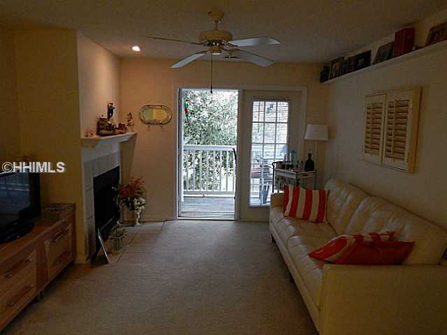 Living room view of fireplace, deck - 100 Kensington Blvd