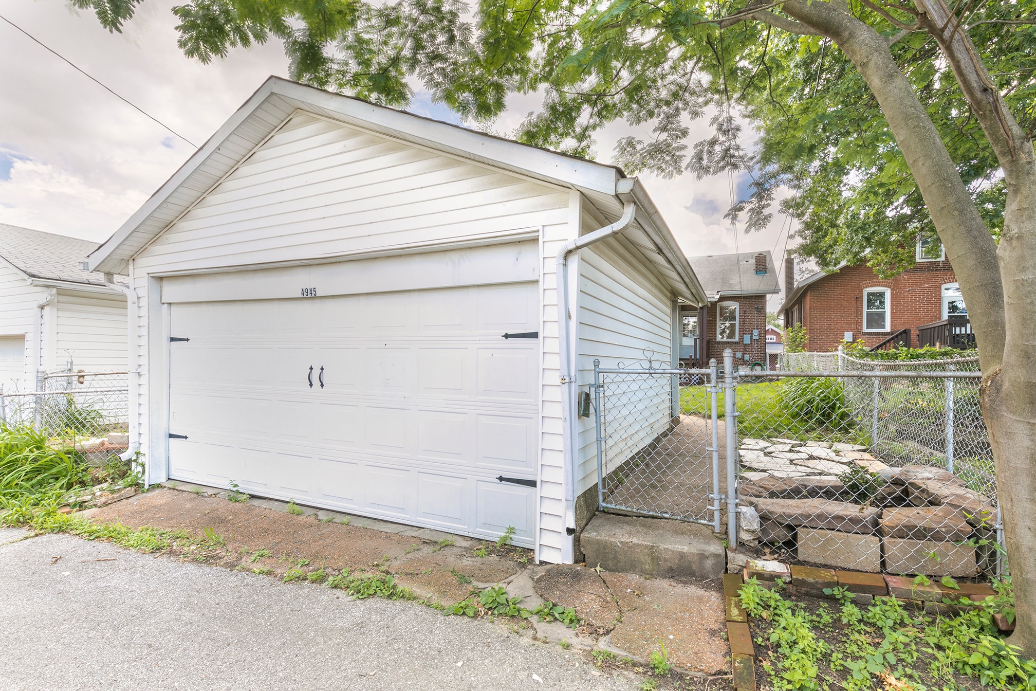 Fenced backyard with fire pit and detached garage - 4945 Delor Street