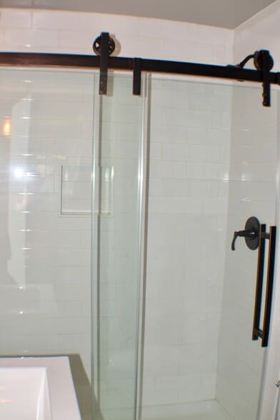 Sliding glass doors in the standing shower of the hall bathroom - 311 Paris Mountain Ave