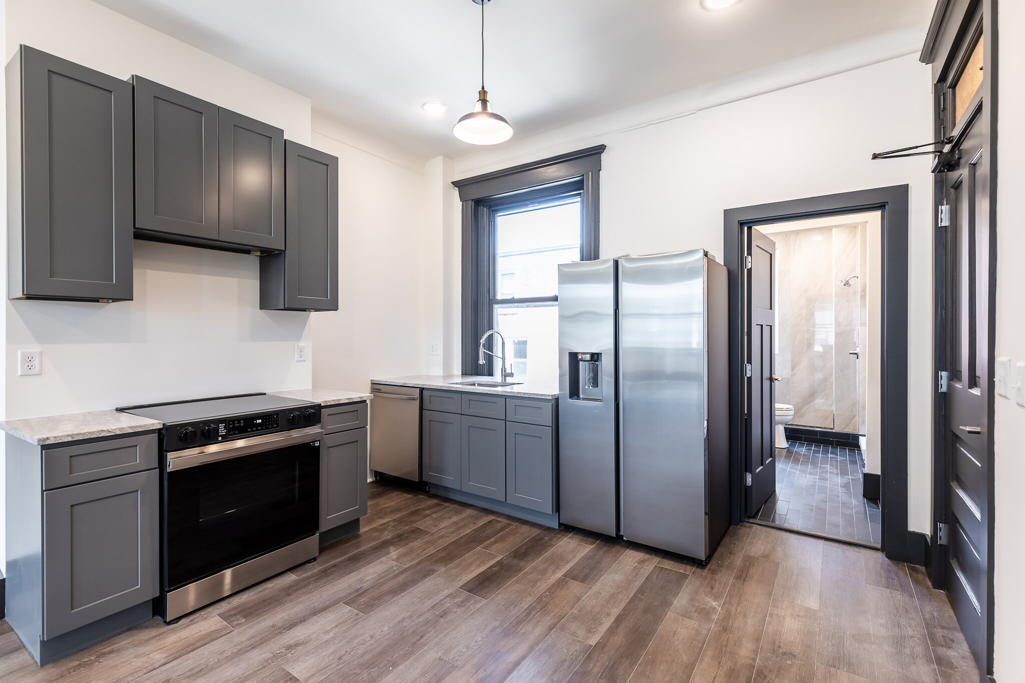 Kitchen with all new appliances, Microwave/hood has been installed. - 728 E McMillan St