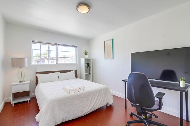 Bedroom 2 is a blend of comfort & productivity, w/ its cozy queen bed & workspace. - 2304 E 14th St