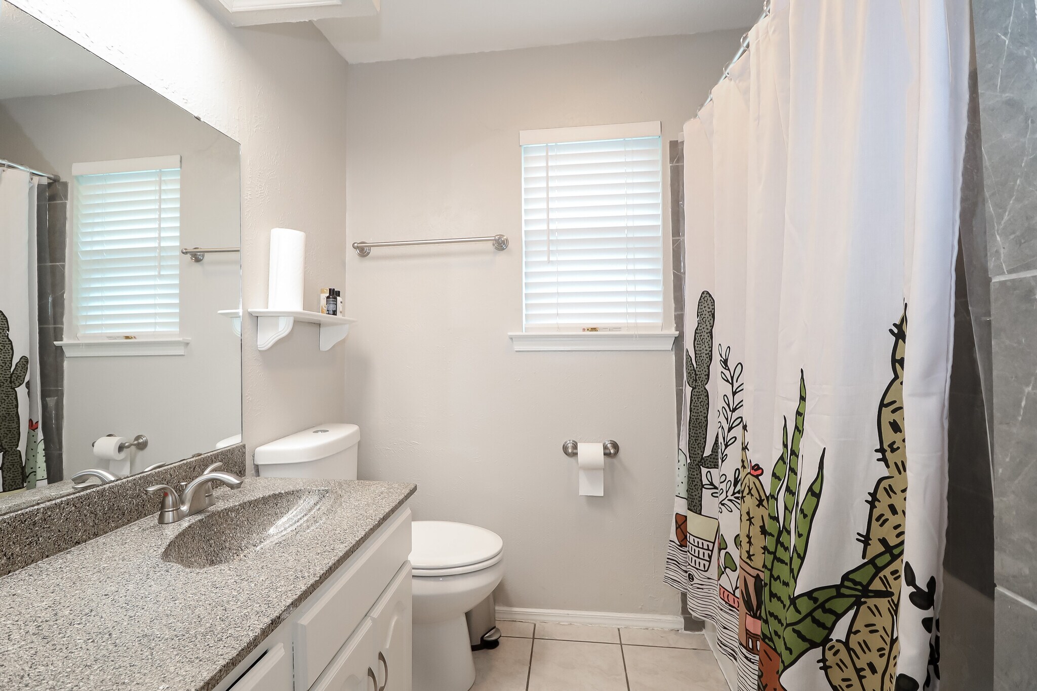The main bath has a shower head in the bathtub and a full-sized linen closet. - 2507 Holt Road