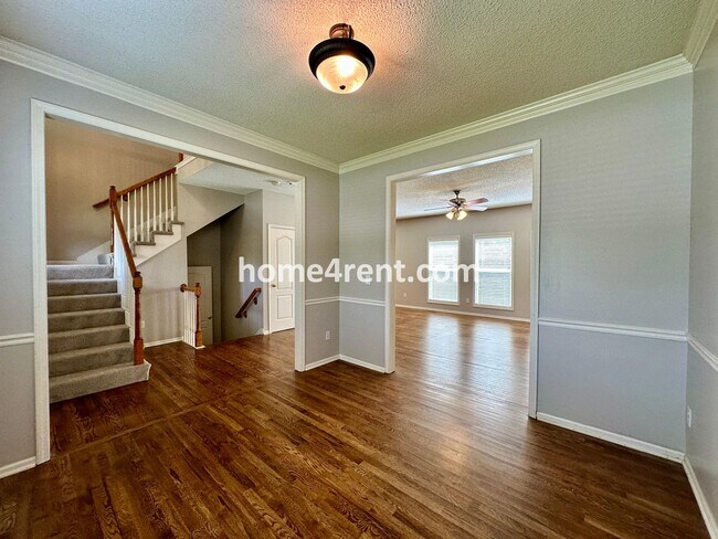 Building Photo - Beautiful Four-Bedroom Home with Three Car Garage, Wood Floors, Finished Basement and a Fenced Ya...