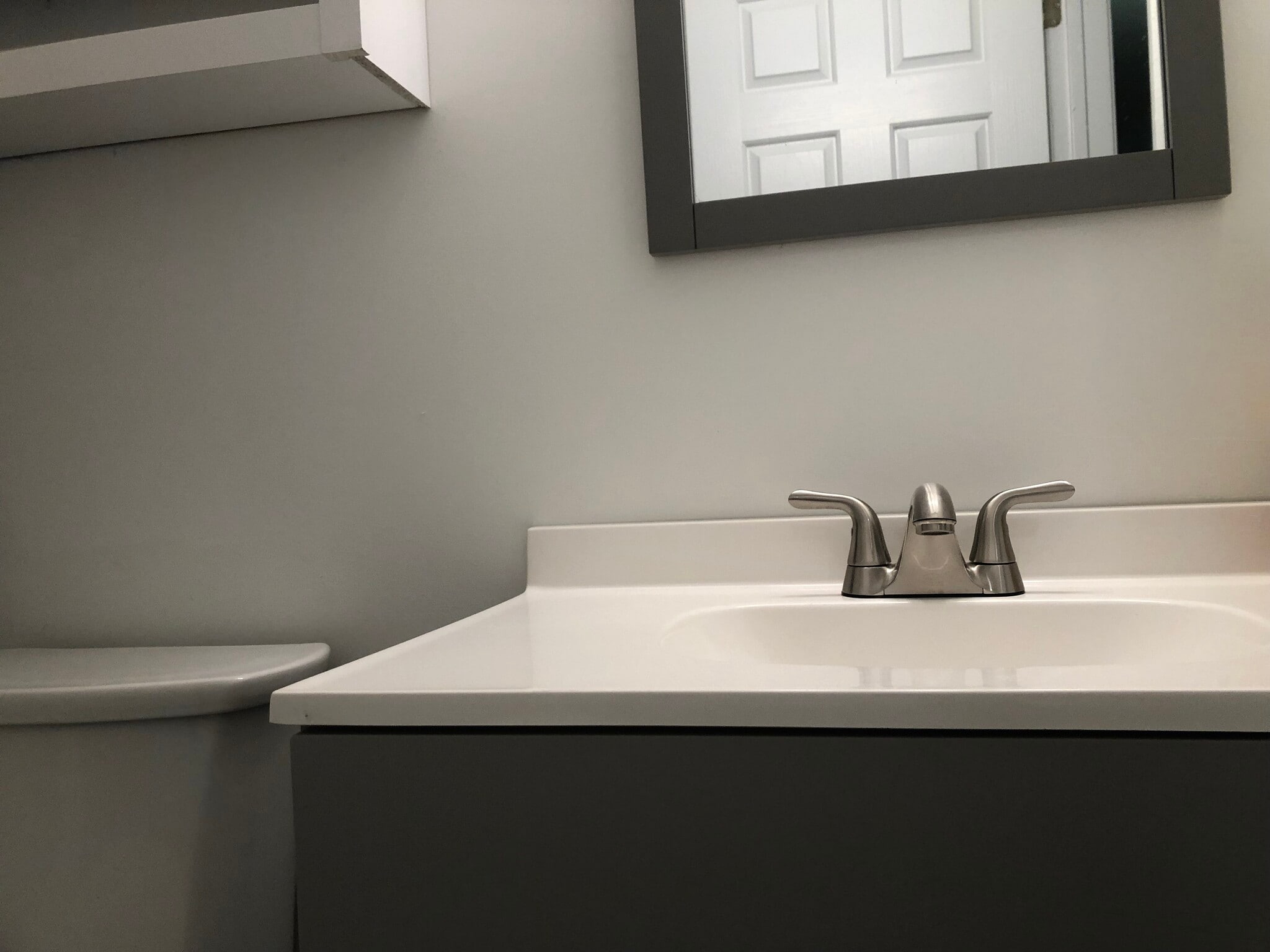 Fresh vanity, countertop, and mirror in bath. - 261 Simpson Ave