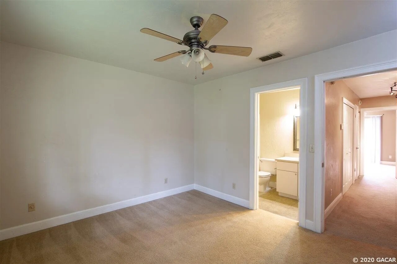 Bedroom #2 w/ view to en-suite bathroom. - 4411 SW 34th St