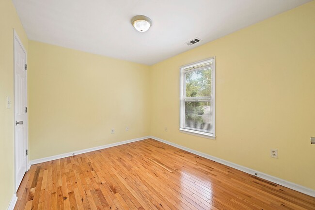 Cozy bedroom with sun kissed windows, offering a serene atmosphere and plenty of room for furniture - 247 Farrington Ave SE