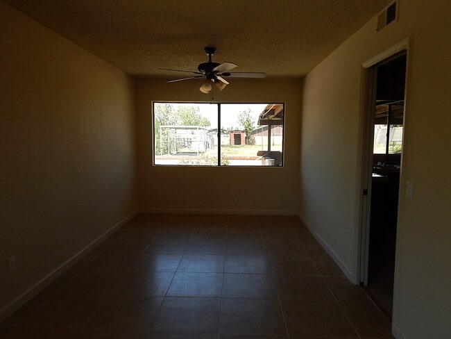 Building Photo - This property is a 3 bedroom, 2 bathroom home featuring an open floor plan with tile throughout. ...