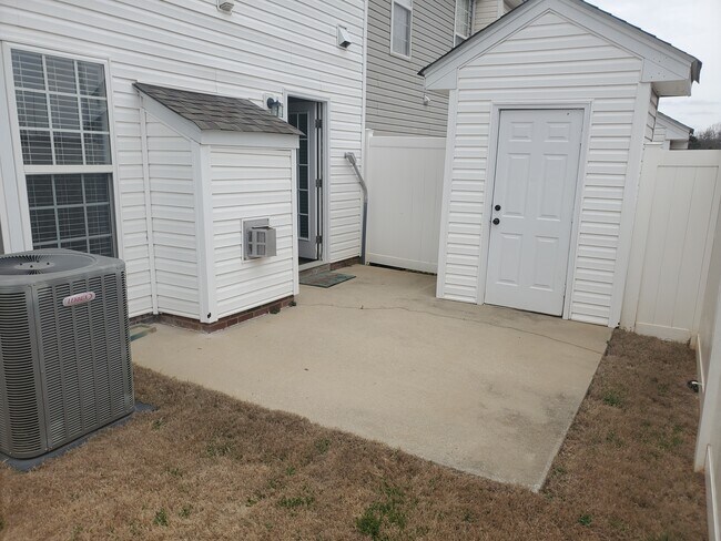 Private outdoor space with view of shed storage and back door. - 42 Gr-Pd-51