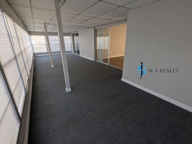 Building Photo - 2/2/1 with  RENOVATED baths & kitchen, fenced yard, NEW lvp flooring and a OVERSIZED lanai!