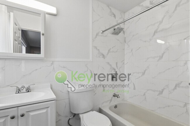 Building Photo - Spacious 2BR/2BA Duplex in Gated Community with Parking, Washer/Dryer & NYC Skyline Views