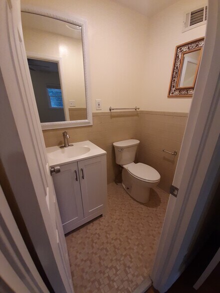 The half bathroom has a newer vanity, sink, and single-handle faucet. - 2955 Fantasy Ln