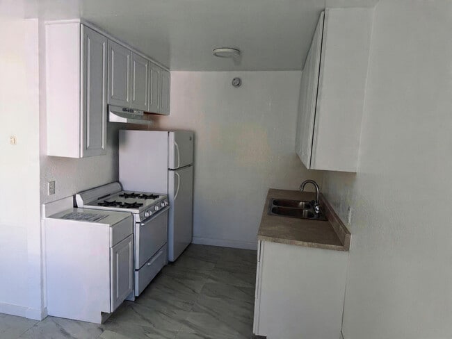 Virtual Staged to show Fridge is included - Churchill Apartments