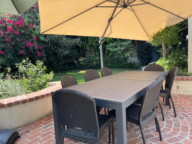 Enjoy the expandable dining table, cantilever umbrella, and two chaise lounges. - 9338 Oakmore Rd