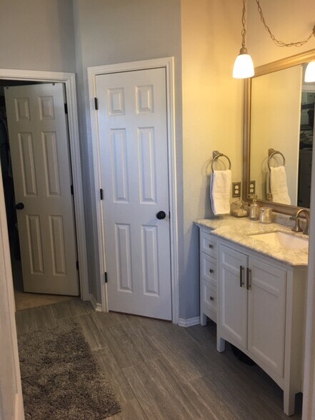 master bathroom, view door to toilet room on right, and door to master closet - 3809 Willie Mays Ln