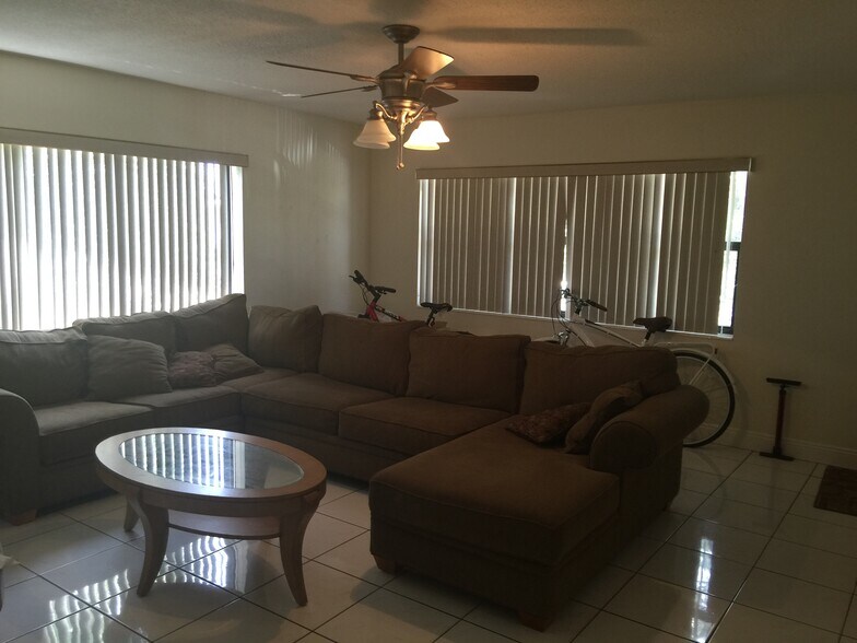 furnished living room sectional, tables, and Tv - 260 SW 7th St