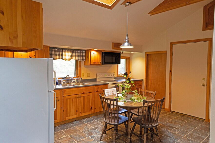 Kitchen/dining area & doors to laundry & stairwell - 64 Gardner Rd