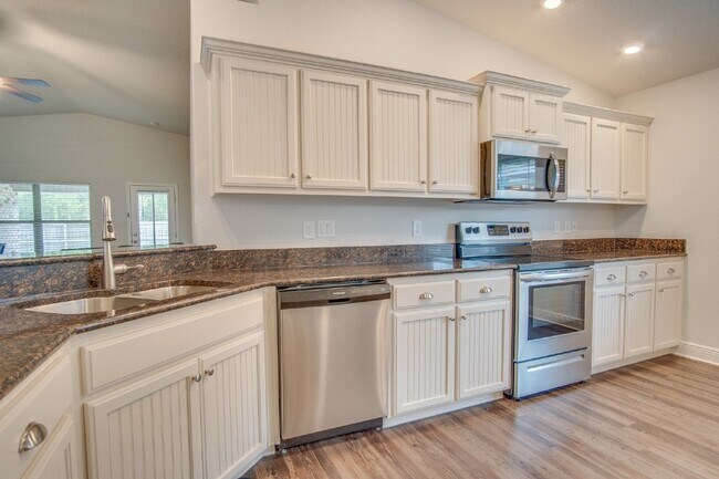 Building Photo - Spacious 4BR/2BA Brick Home with 2-Car Garage, Granite Kitchen, Vaulted Ceilings & Fully Fenced B...