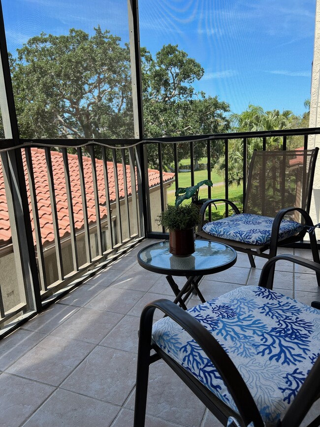 Patio lanai with partial view of golf course and pond - 6219 Palma Del Mar Blvd S