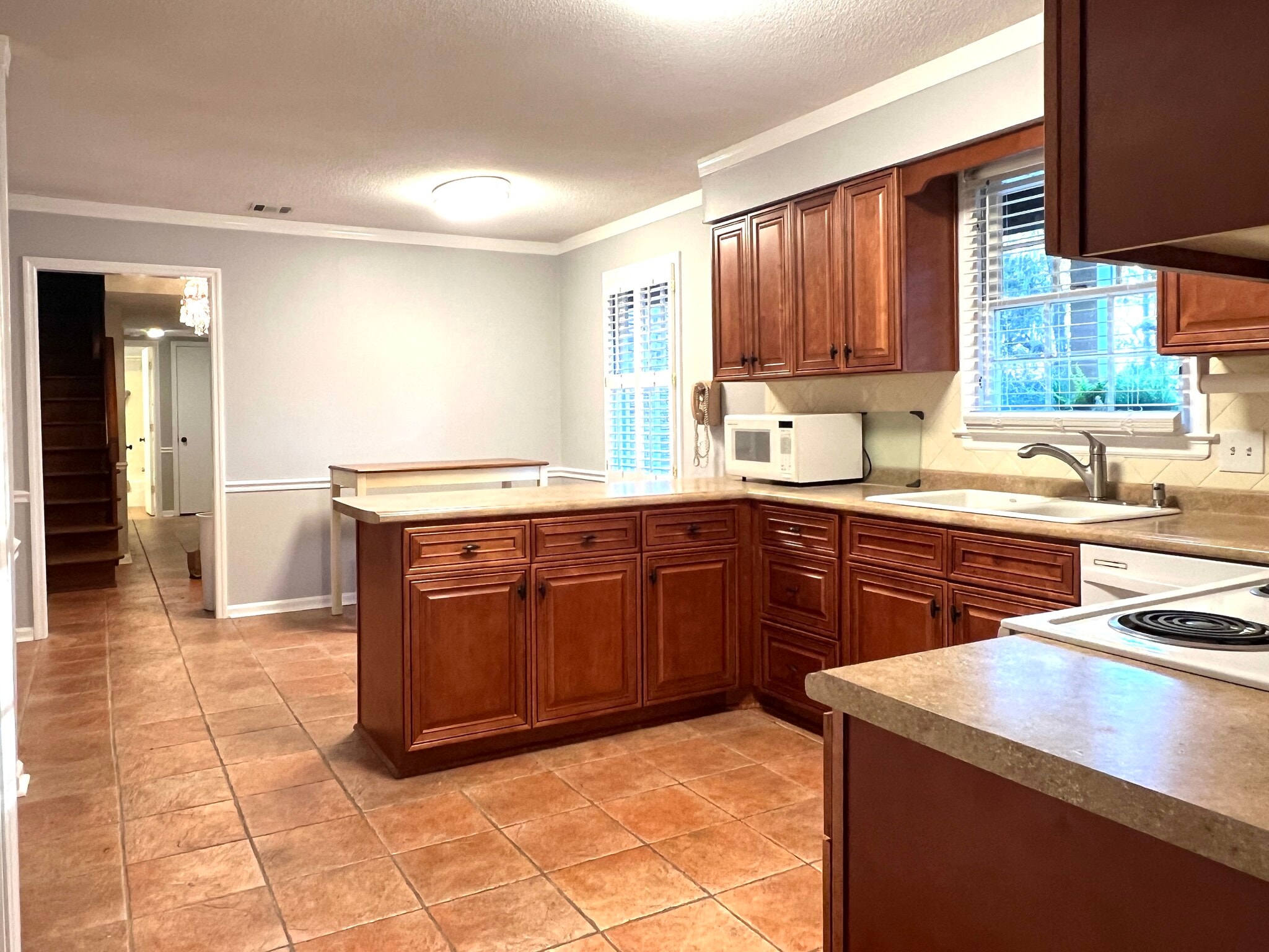 The large, fully equipped kitchen has the peninsula and a dining area - 902 Penn Waller Rd
