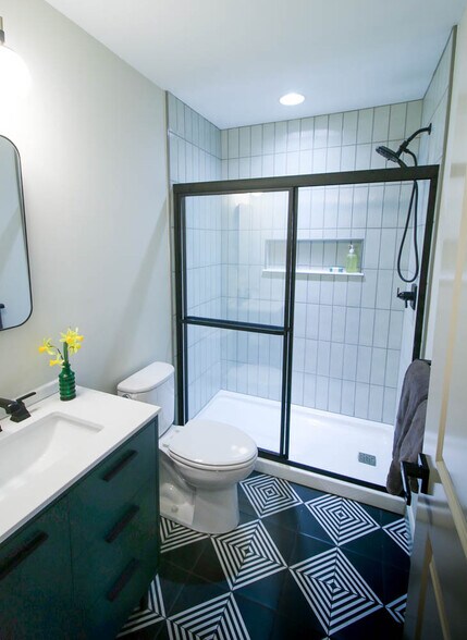 Second full bathroom with modern accented tiles and glass shower doors - 2406 Boswell Rd
