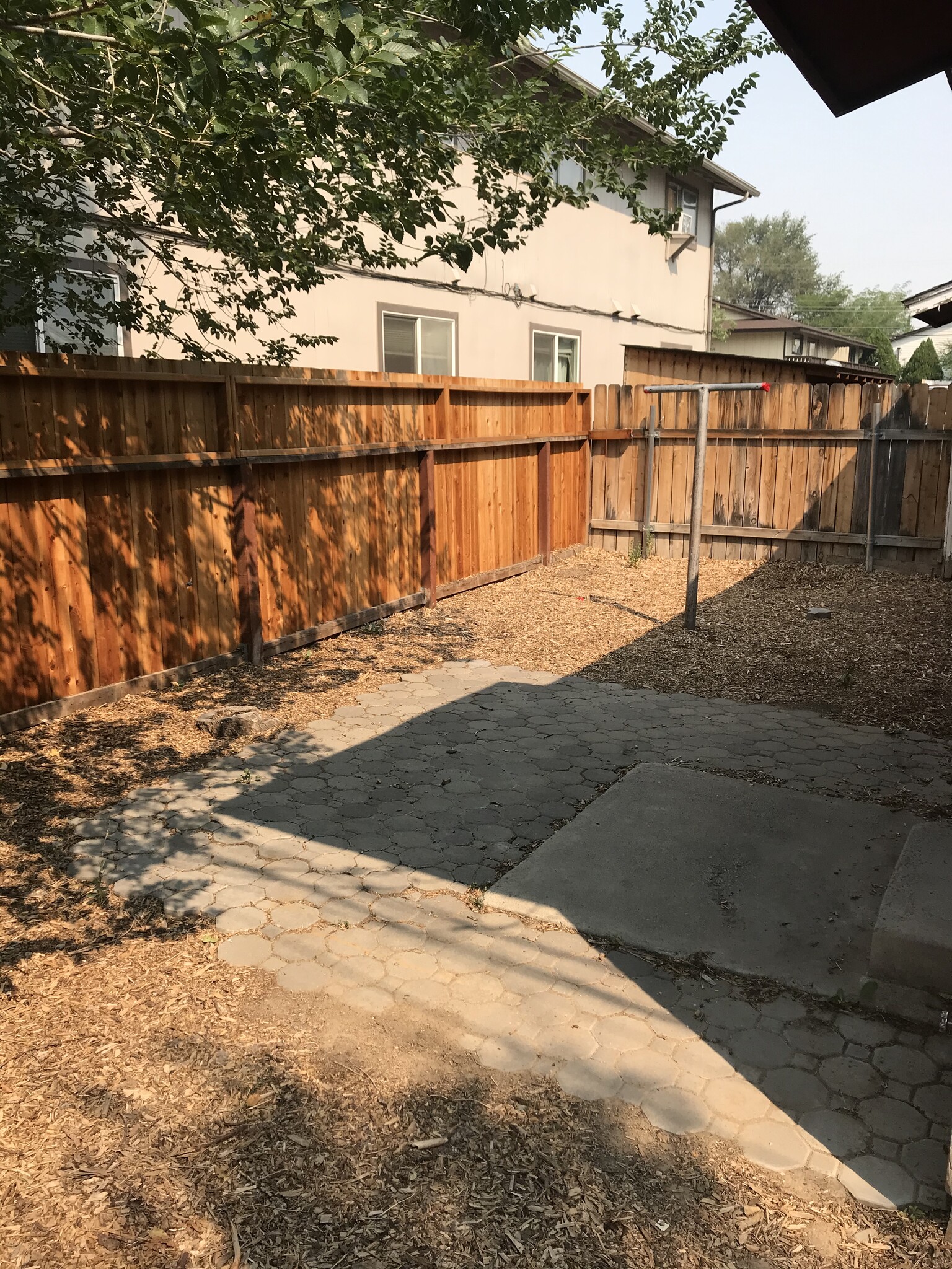 Backyard with a patio and new privacy fencing. - 1132 Parkview Street