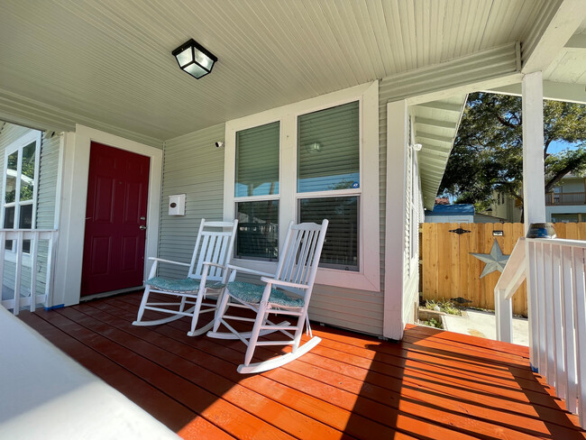 ring porch showing two rocking chairs. The storage shed in the backyard is a home gym. - 422 S Olive St