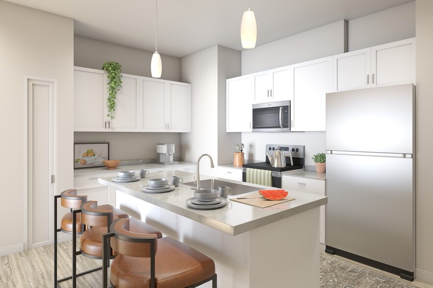 Flats at Sugar Run Delaware Ohio apartments showing a kitchen with white cabinets and a refrigerator. - Flats at Sugar Run