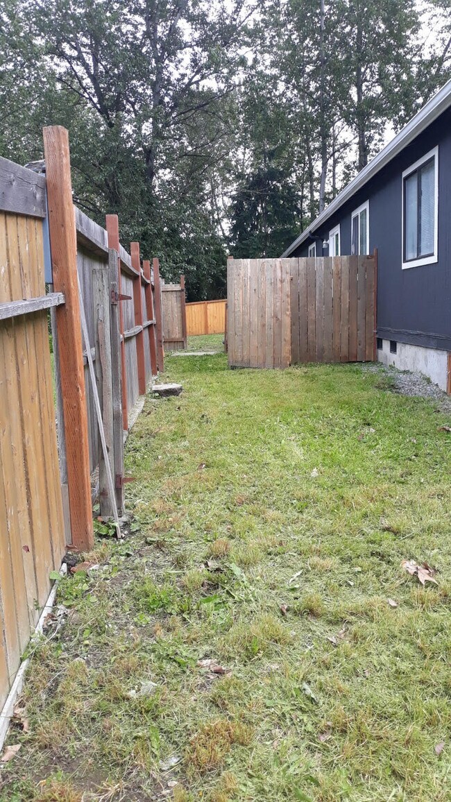 Full fenced backyard w/ landscaping included - 219 E 36th St