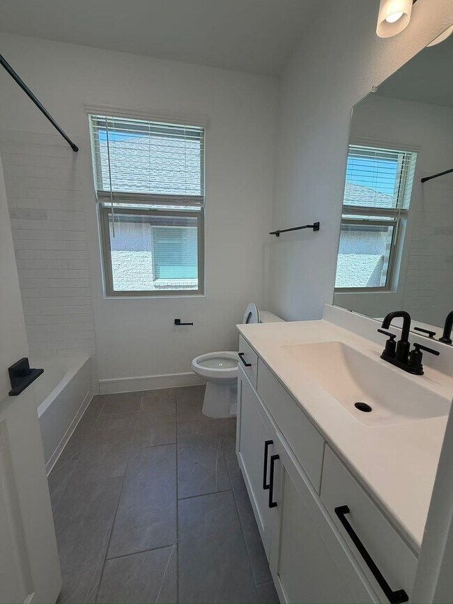 Building Photo - Move-in ready and like-new! Washer, dryer, and refrigerator Included.