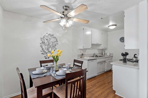 Modern and bright dining room and the kitchen at the Ridgeview Apartment with plank flooring - The Ridgeview