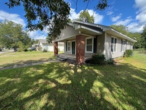 Building Photo - Three bedroom two bath home with central heat and air, large fenced backyard, and carport!