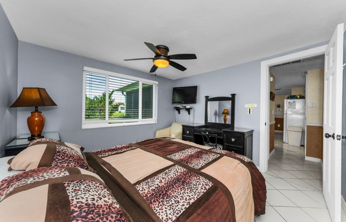 2nd bedroom (water view!) Queen size bed with canal water view. Vanity, night stand, closet and TV - 3931 Sail Dr