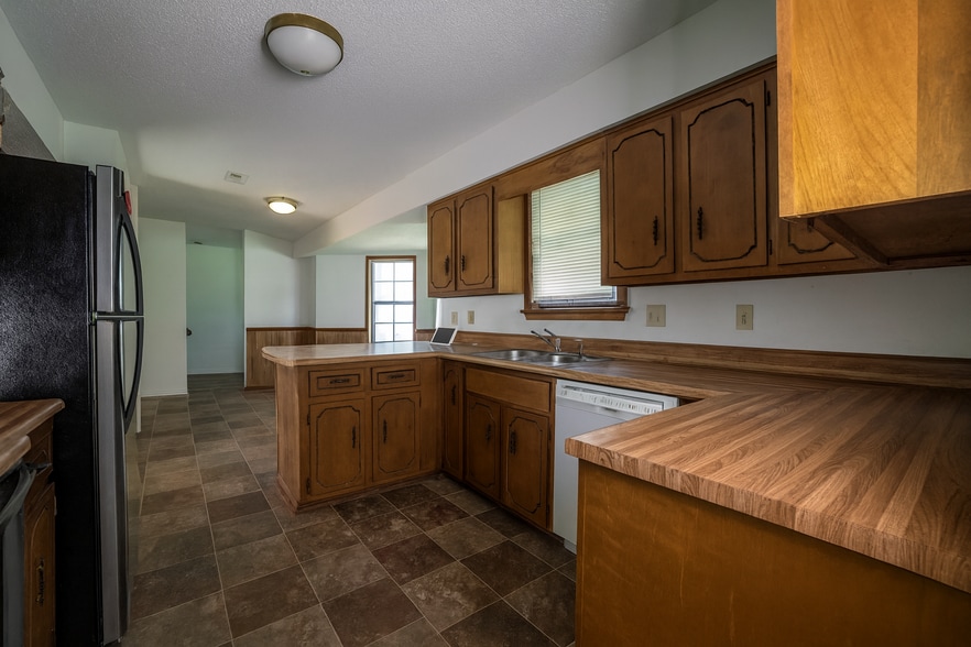 Spacious kitchen with ample storage, breakfast bar, and double sink for easy entertaining. - 2313 Salem West Dr