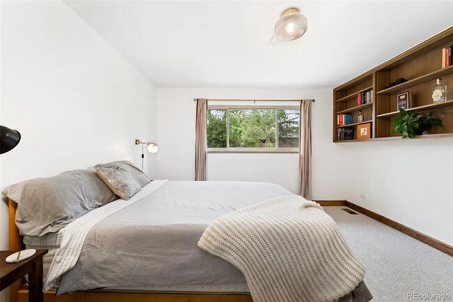 Second bedroom with closet and built-in shelving. - 516 Monaco Pky