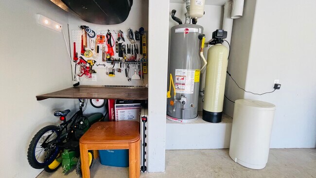 Retractable workbench, water softener, car topper hooks, chest freezer fits under workbench - 7108 Garnet Mill Ln