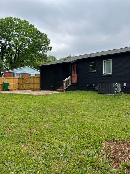 Rear entry of home leads to a concrete patio and the expansive yard - 2311 Crestview Drive