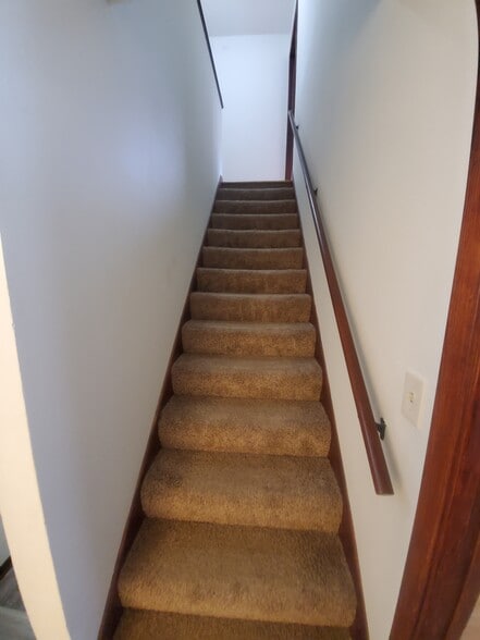 Stairway leading to upstairs bedrooms and full bathroom Carpeted 2 years ago - 1182 Lane Pl