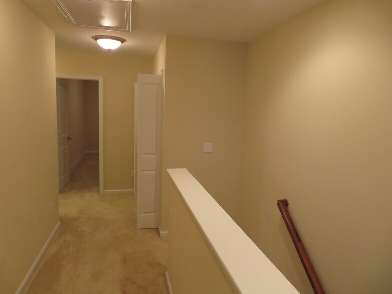 View across loft from Master Suite door. 2nd Bedroom straight ahead, Laundry Closet on right - 2496 Stadium Dr