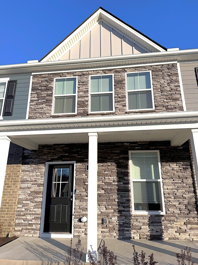 This stone front two-story townhome is brand new. It is within one block of the community pool. - 403 Augustine Dr